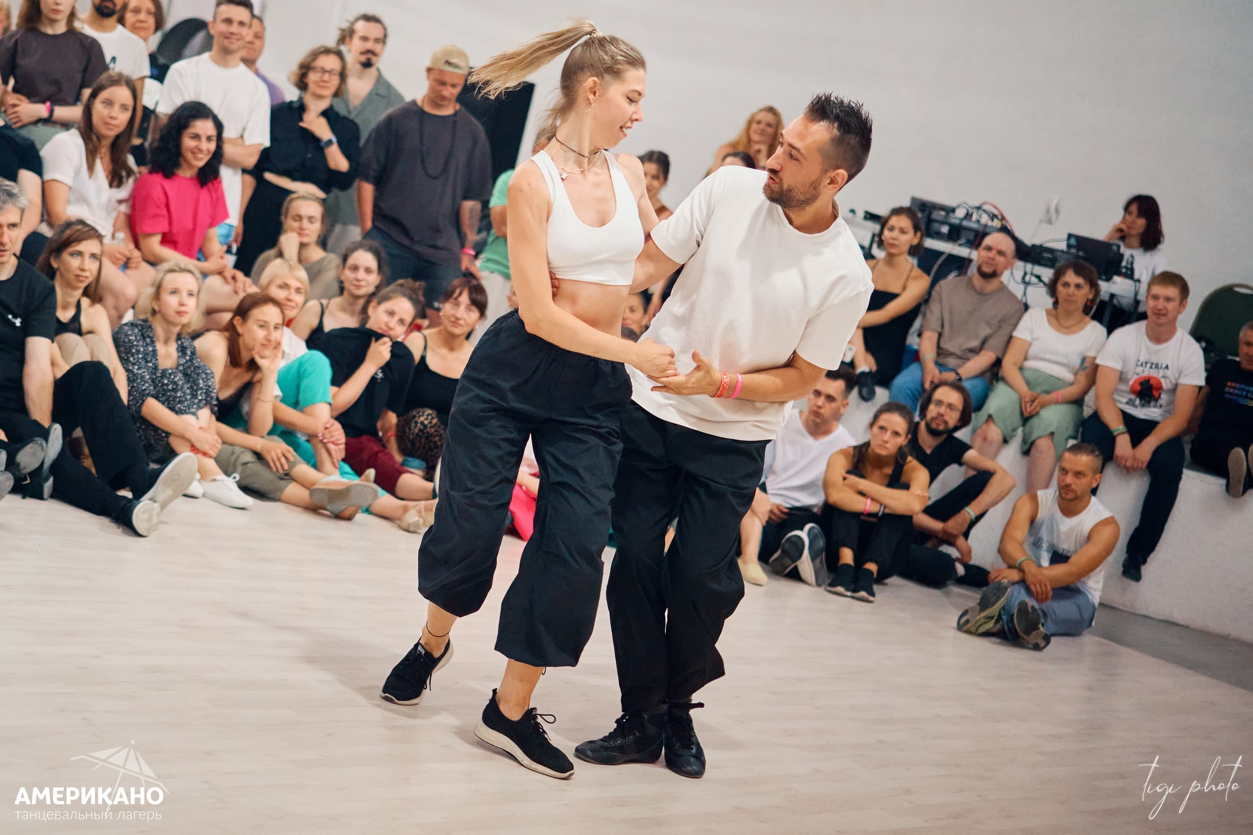 West Coast Swing dancers in a bright social moment