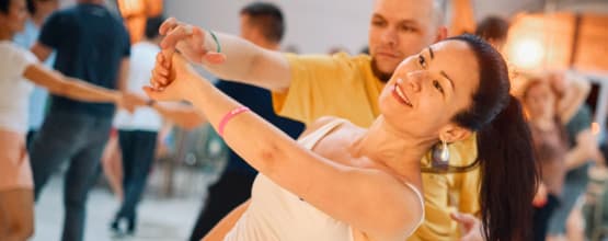 West Coast Swing social dance with warm evening lighting
